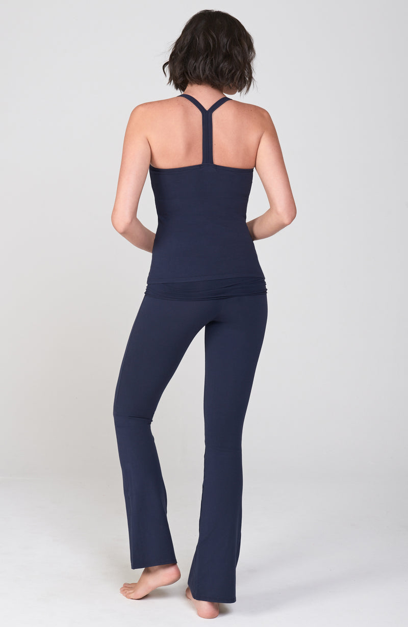 Back view of Navy Blue Organic cotton lycra bootcut Activewear pant with flare leg. Shirred detail waist overlay. Worn with matching Navy T back Active Tank.