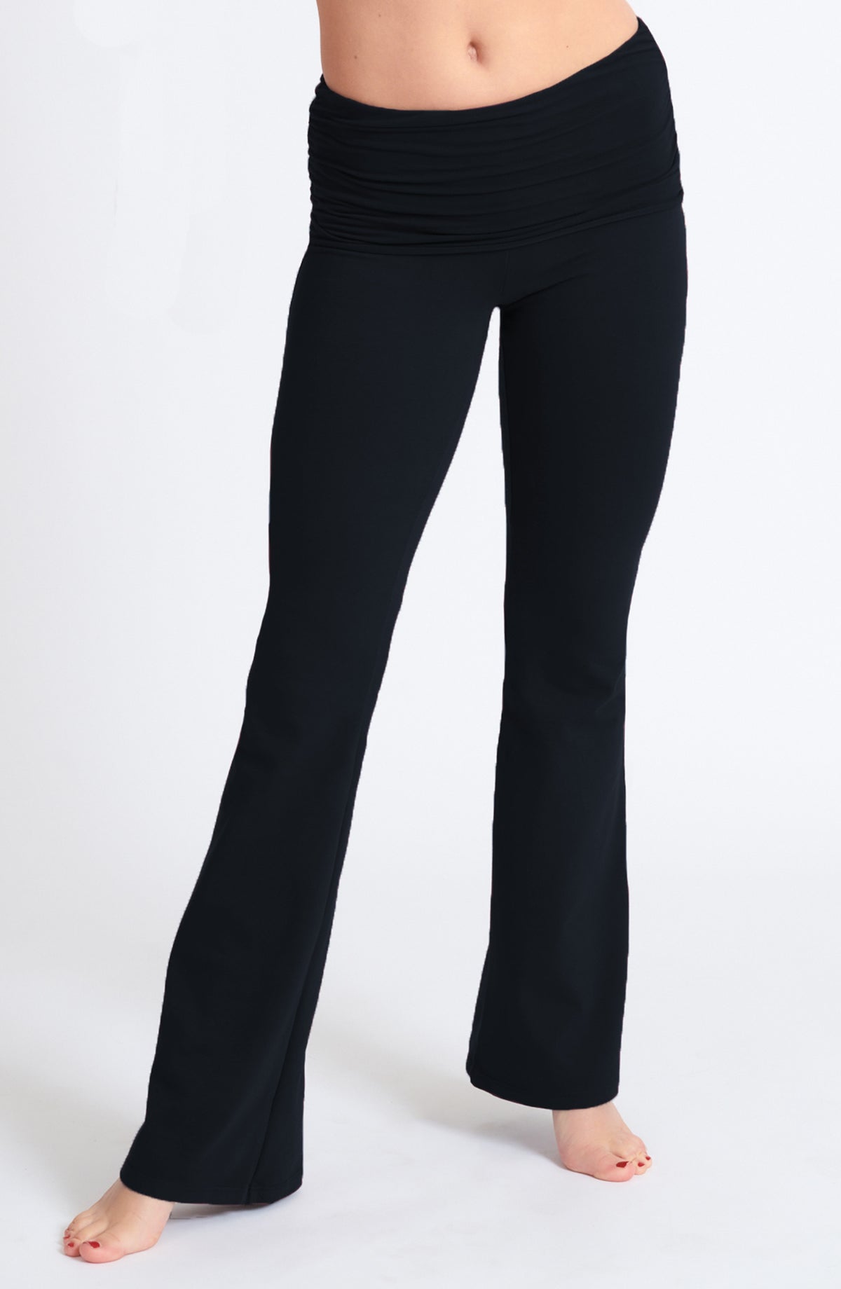closeup of fitted Black Organic cotton lycra bootcut flare  pant with shirred detail waist overlay.